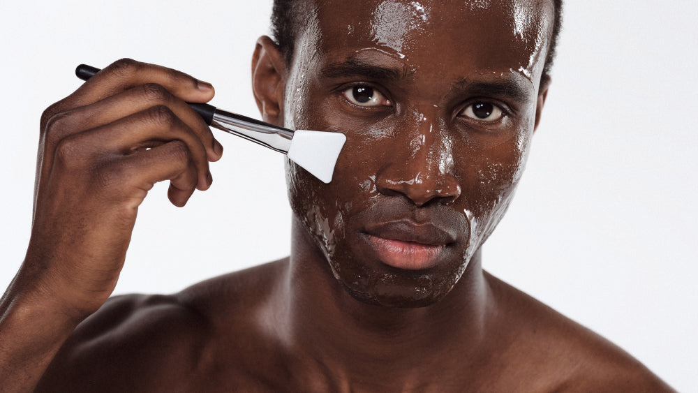 A man applying fruit acid peeling with a brush